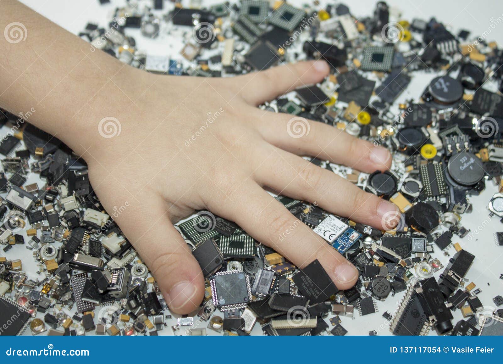 smt components and a child hand in them.