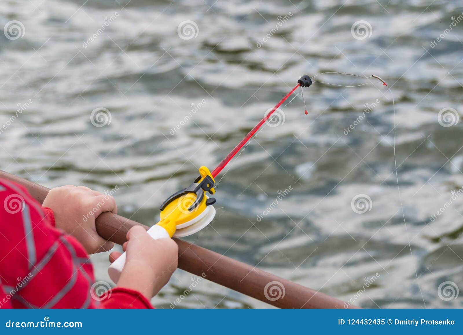 A Child`s Hand is Fishing on a Small Fishing Rod. Ozernaya Fishing