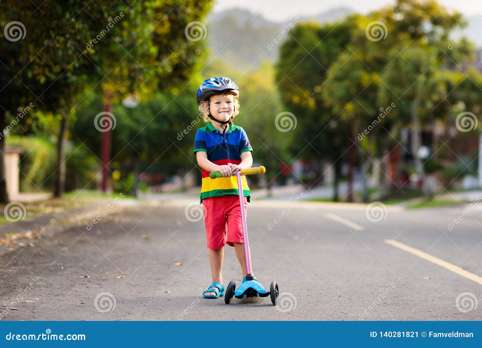 child on scooter in summer. kids skate