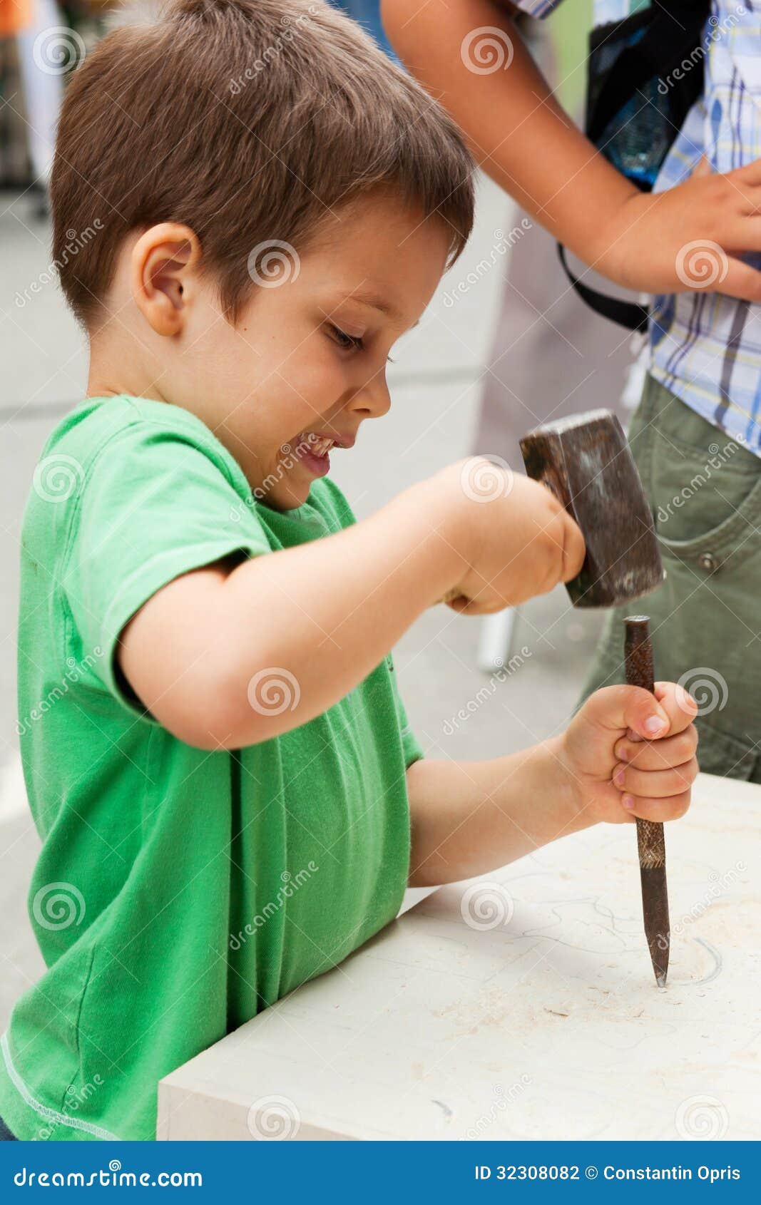 child sculptor with chisel