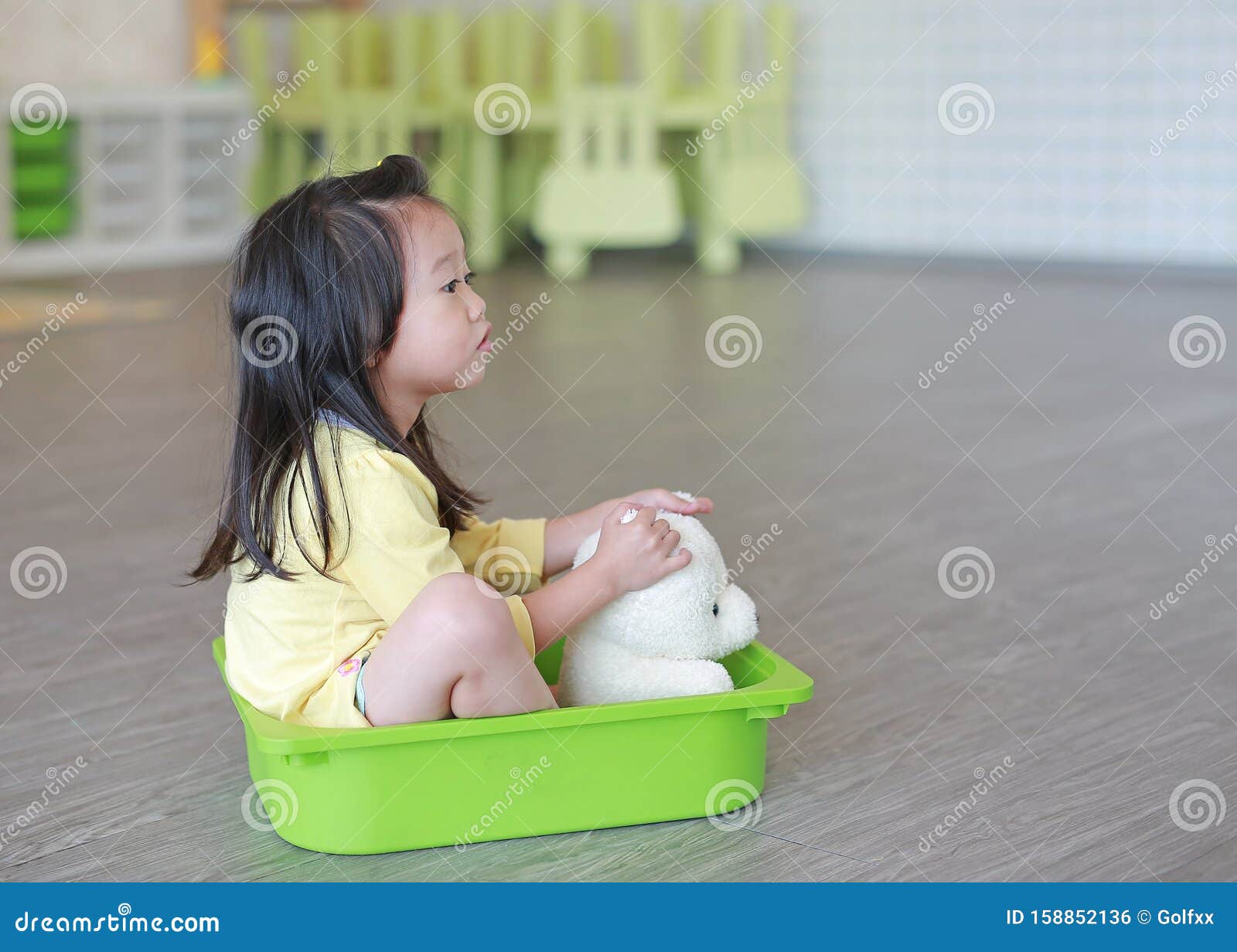 Child Sitting in Plastic Tray Playing at Playroom Stock Photo - Image ...