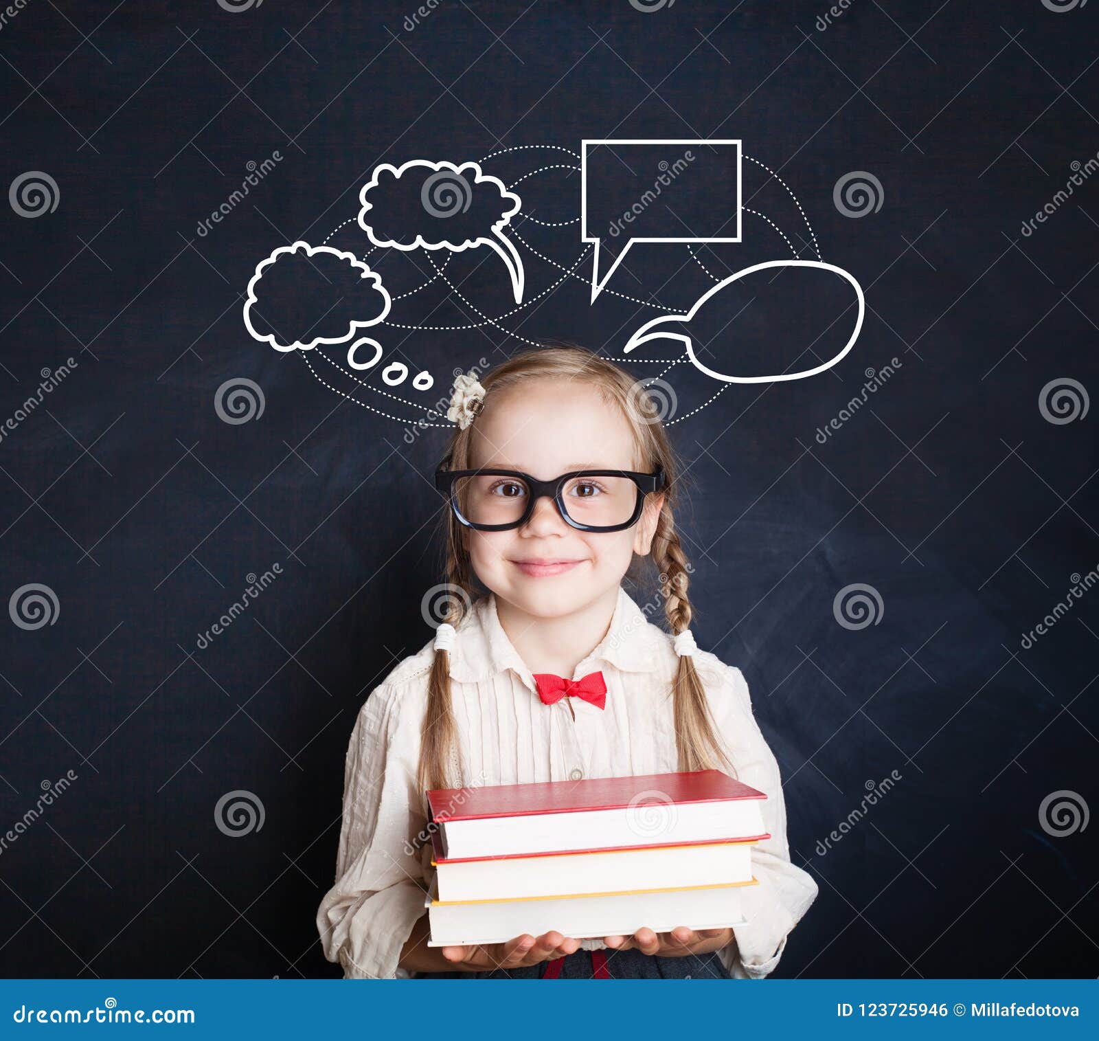 Child Smiling and Holding Books on School Blackboard Stock Photo ...