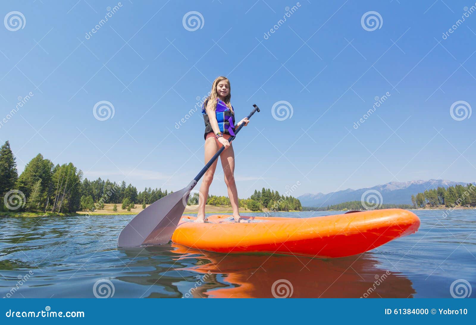 Child On A Stand Up Paddle Board On A Beautiful Mountain Lake Stock ...