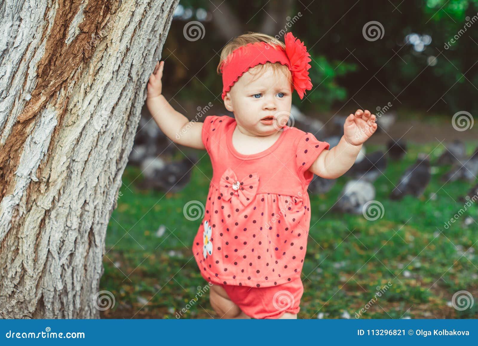 A child stands near a tree stock image. Image of life - 113296821