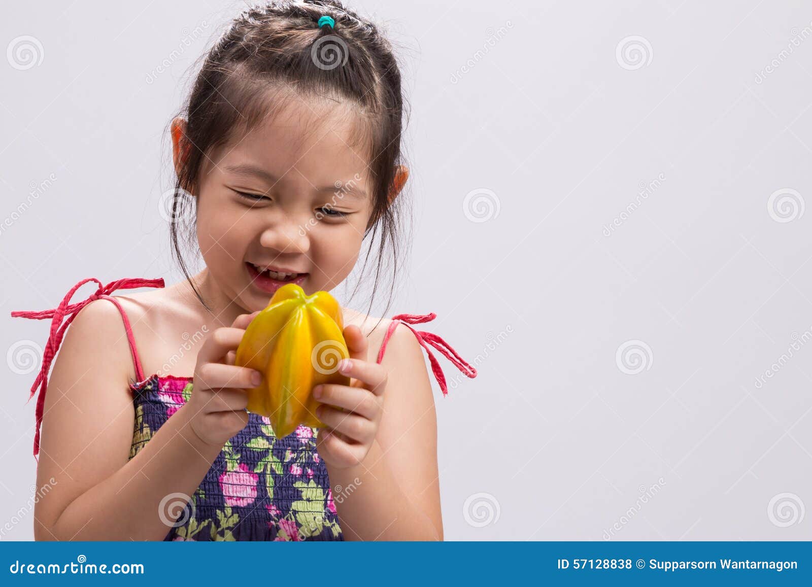 Child with Star Apple / Child Holding Star Apple Background. Child is holding a star apple in her hands background.