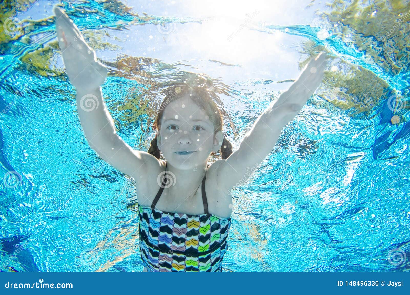 Child Swims Underwater In Swimming Pool, Happy Active 
