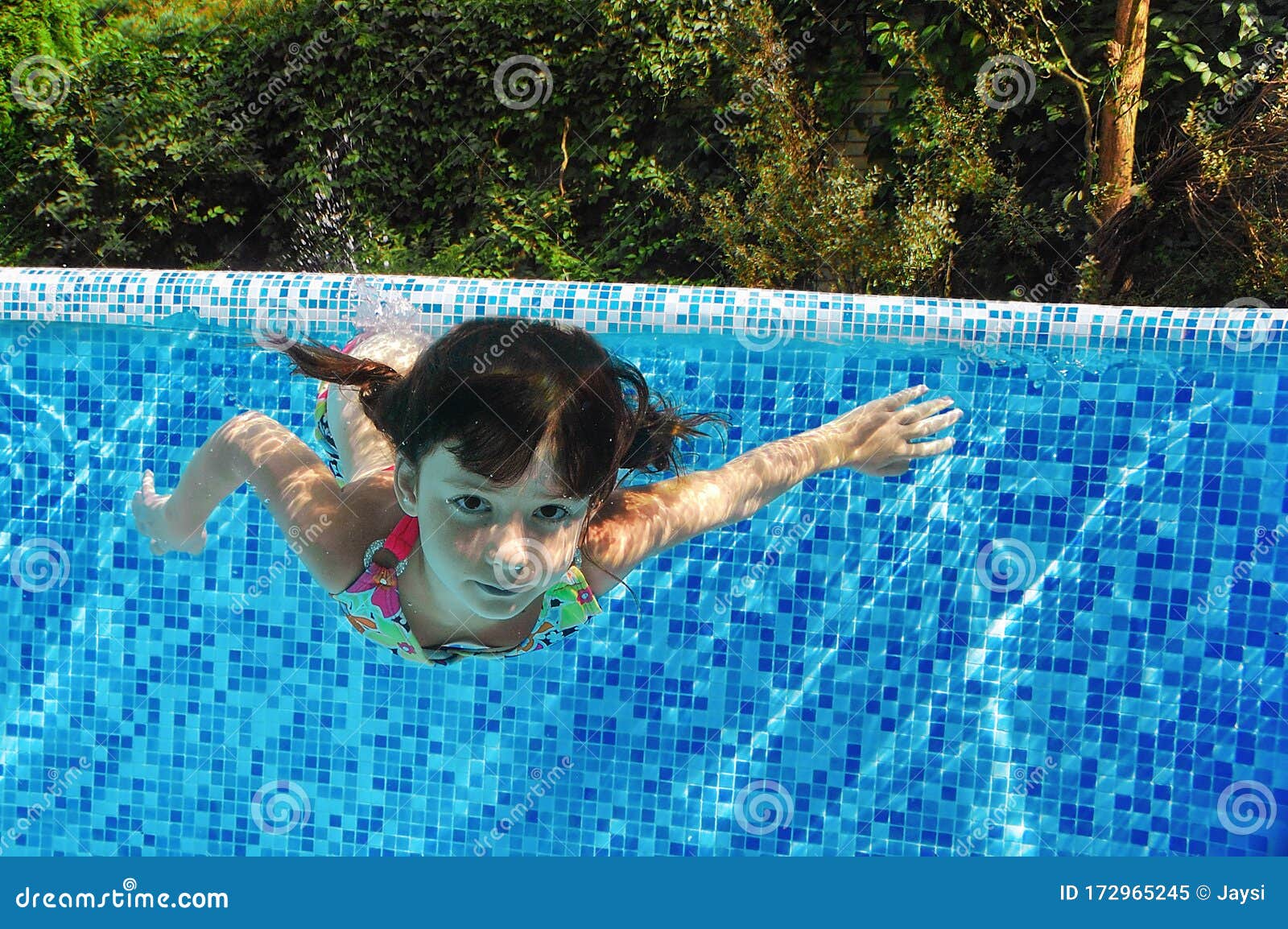 Child Swims Underwater In Swimming Pool, Happy Active 
