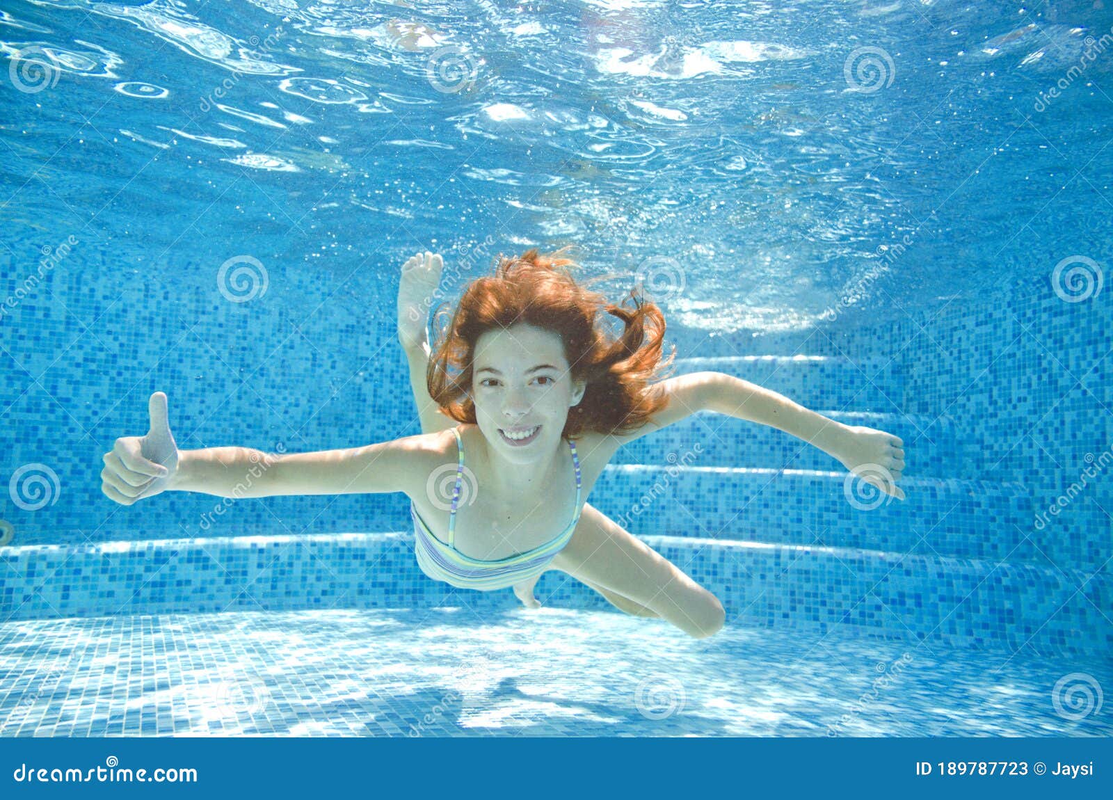 Little Child Swims Underwater In Swimming Pool, Happy 