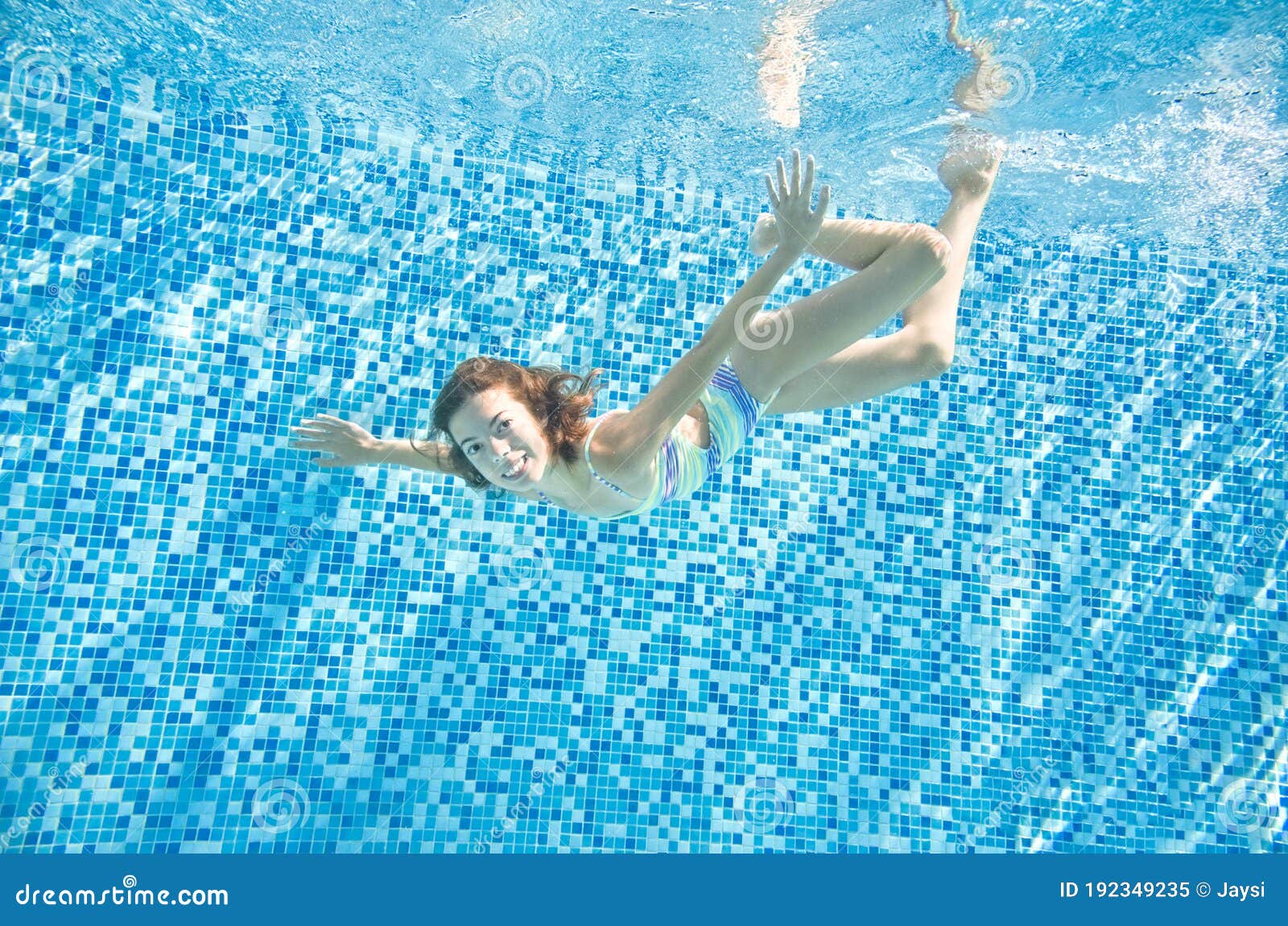 Child Swims Underwater In Swimming Pool, Little Active 