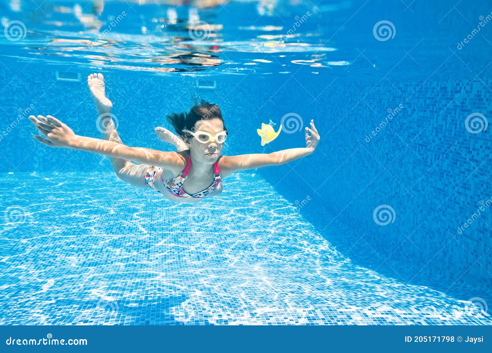 Child Swims Underwater In Swimming Pool, Little Active 