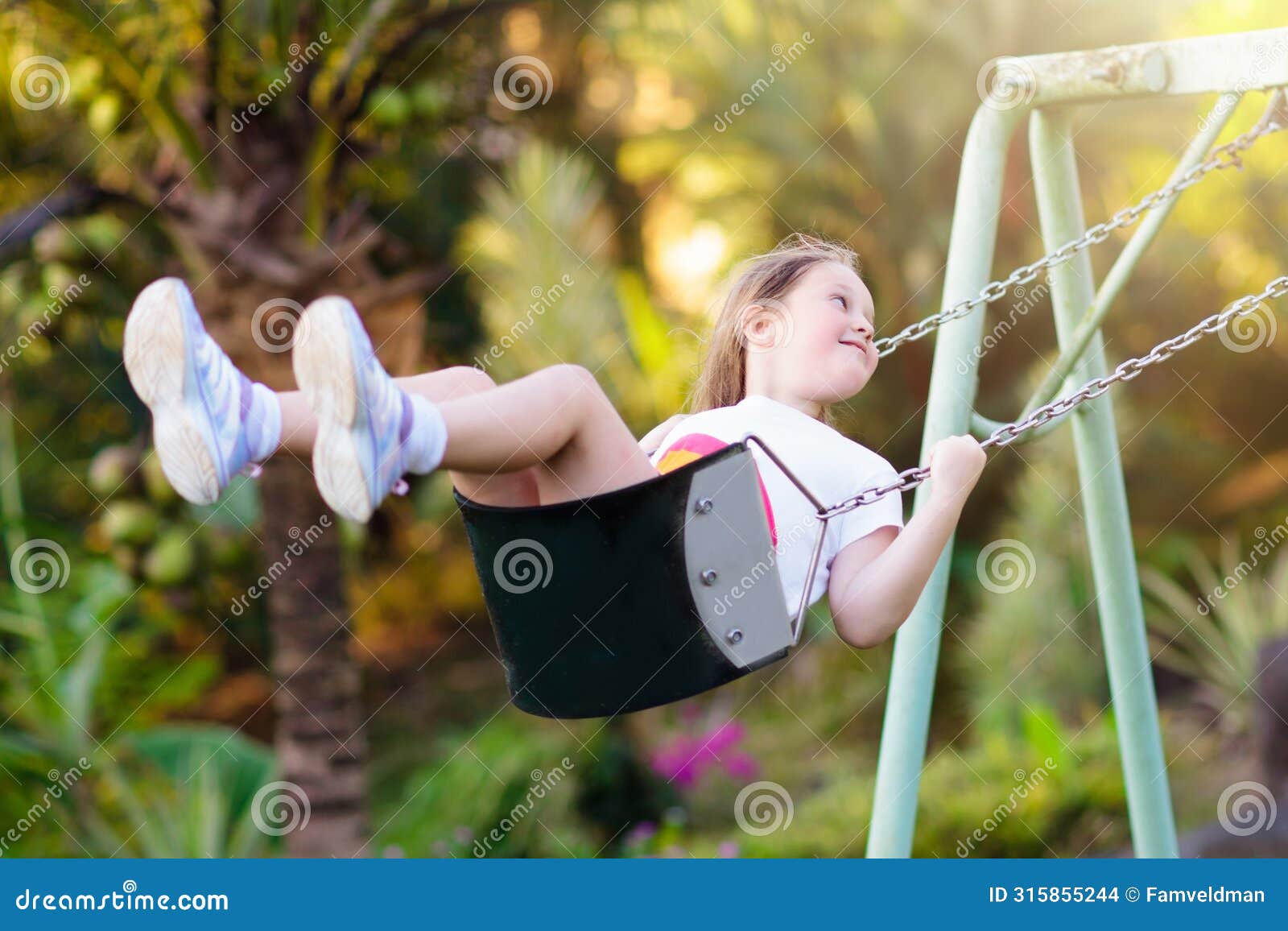child swinging on playground. kids swing