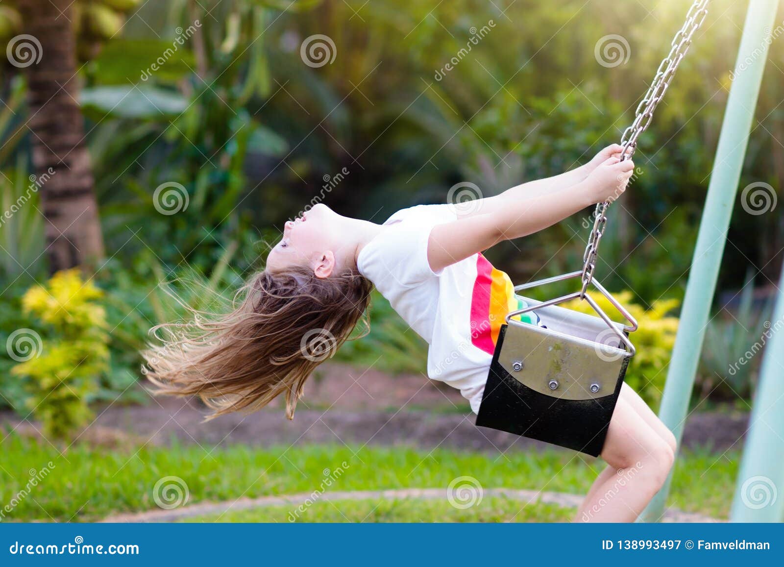 child swinging on playground. kids swing