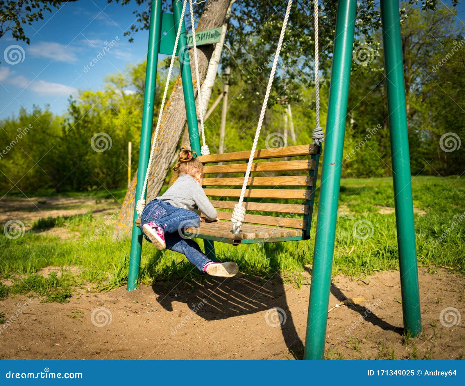 Child Swinging a Swing. Child Sitting on a Swing Stock Image Image of