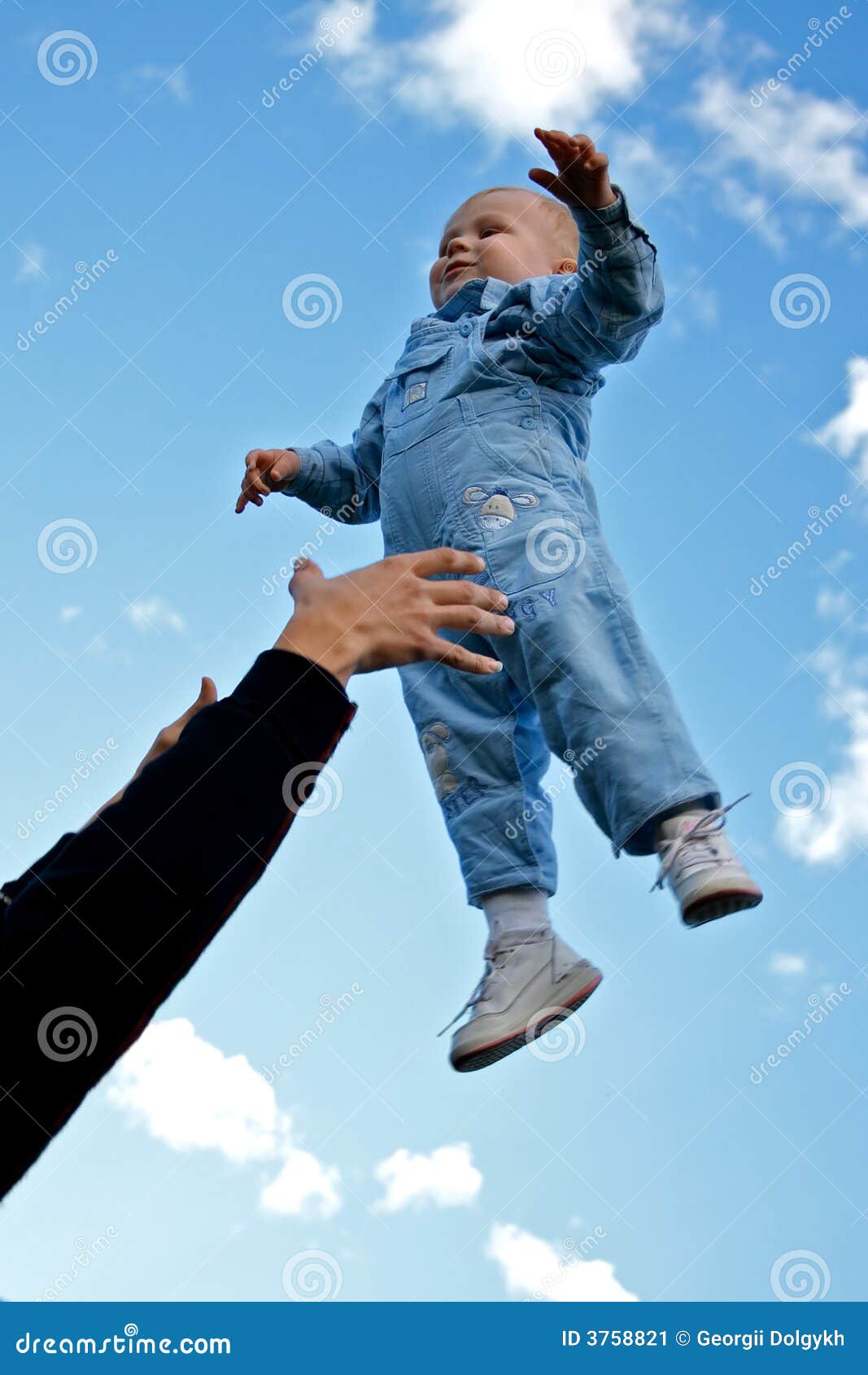 Child thrown up in the air stock image. Image of jumping 3758821