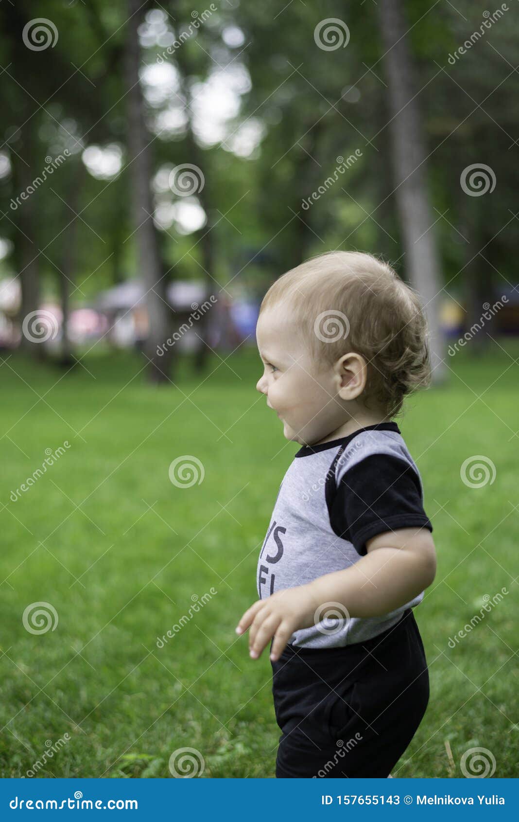 A child walks on the grass stock image. Image of childhood 157655143