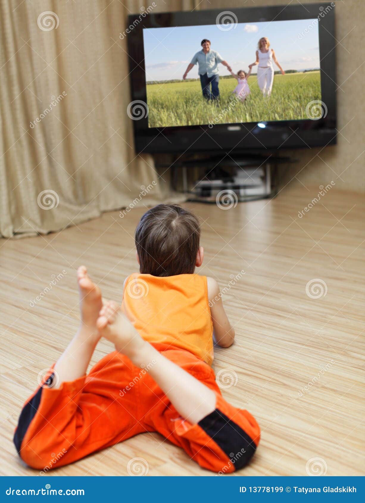 Child watching TV stock image. Image of laying, domestic 13778199