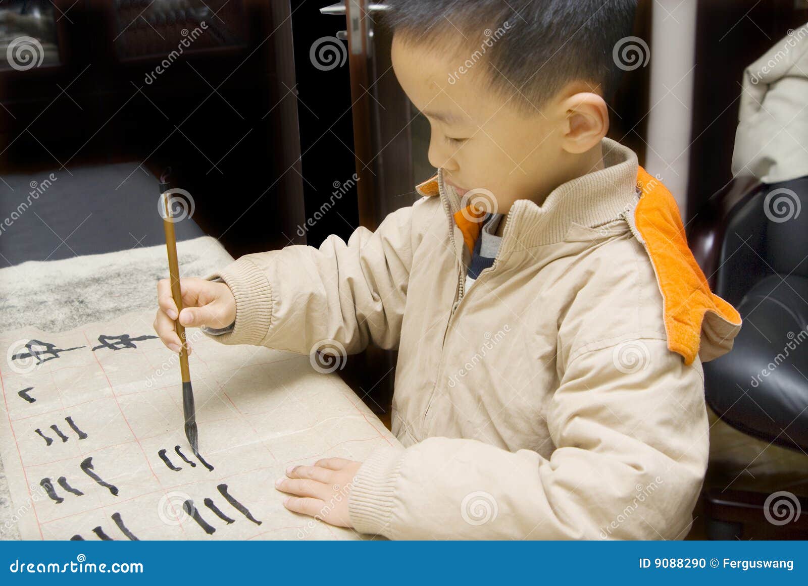 a child writing chinese calligraphy
