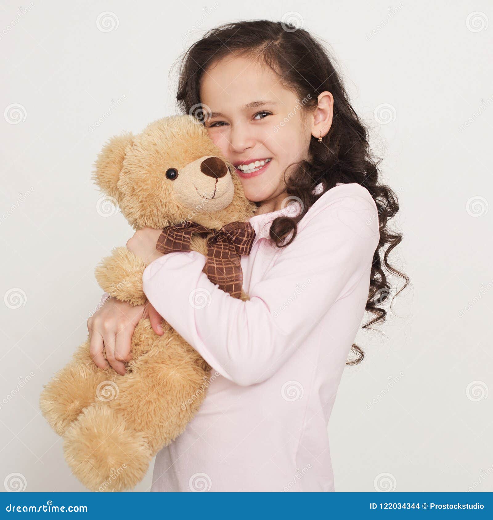 girl hugging big teddy bear