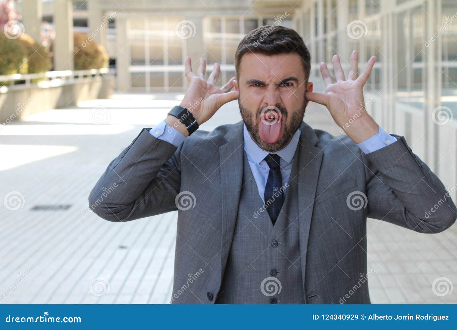 childish businessman doing an obscene gesture