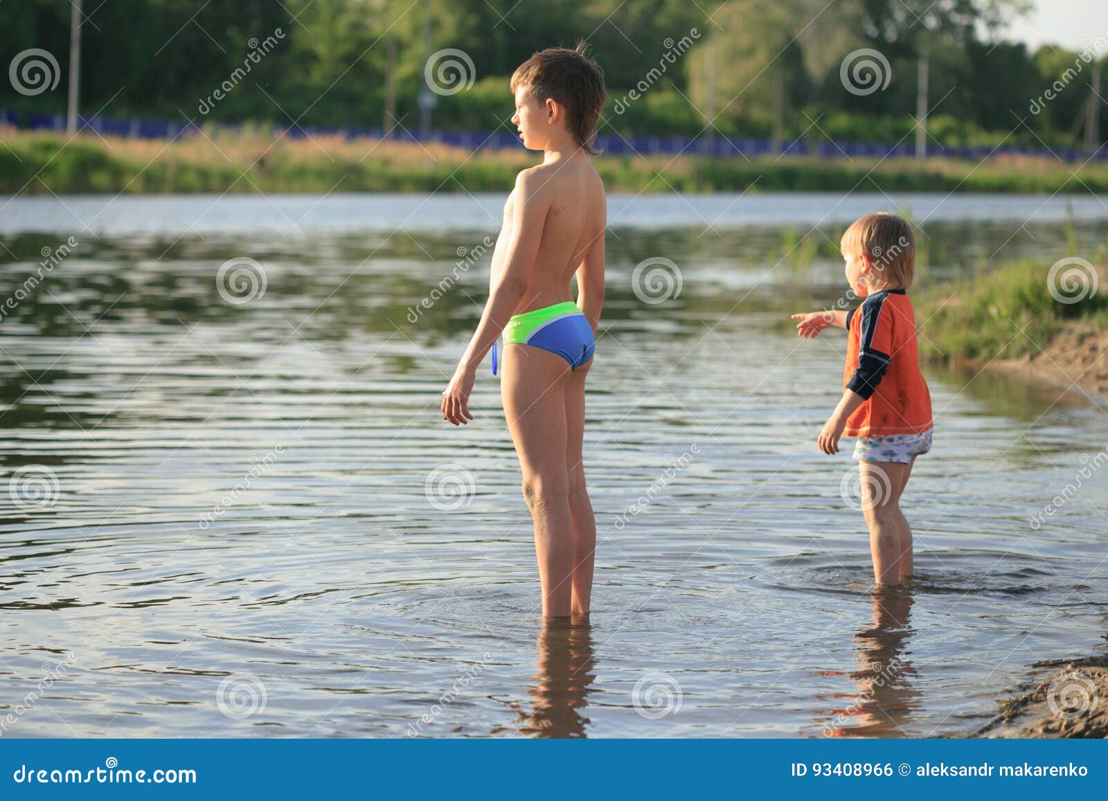 children bathe in the evening on the city beach
