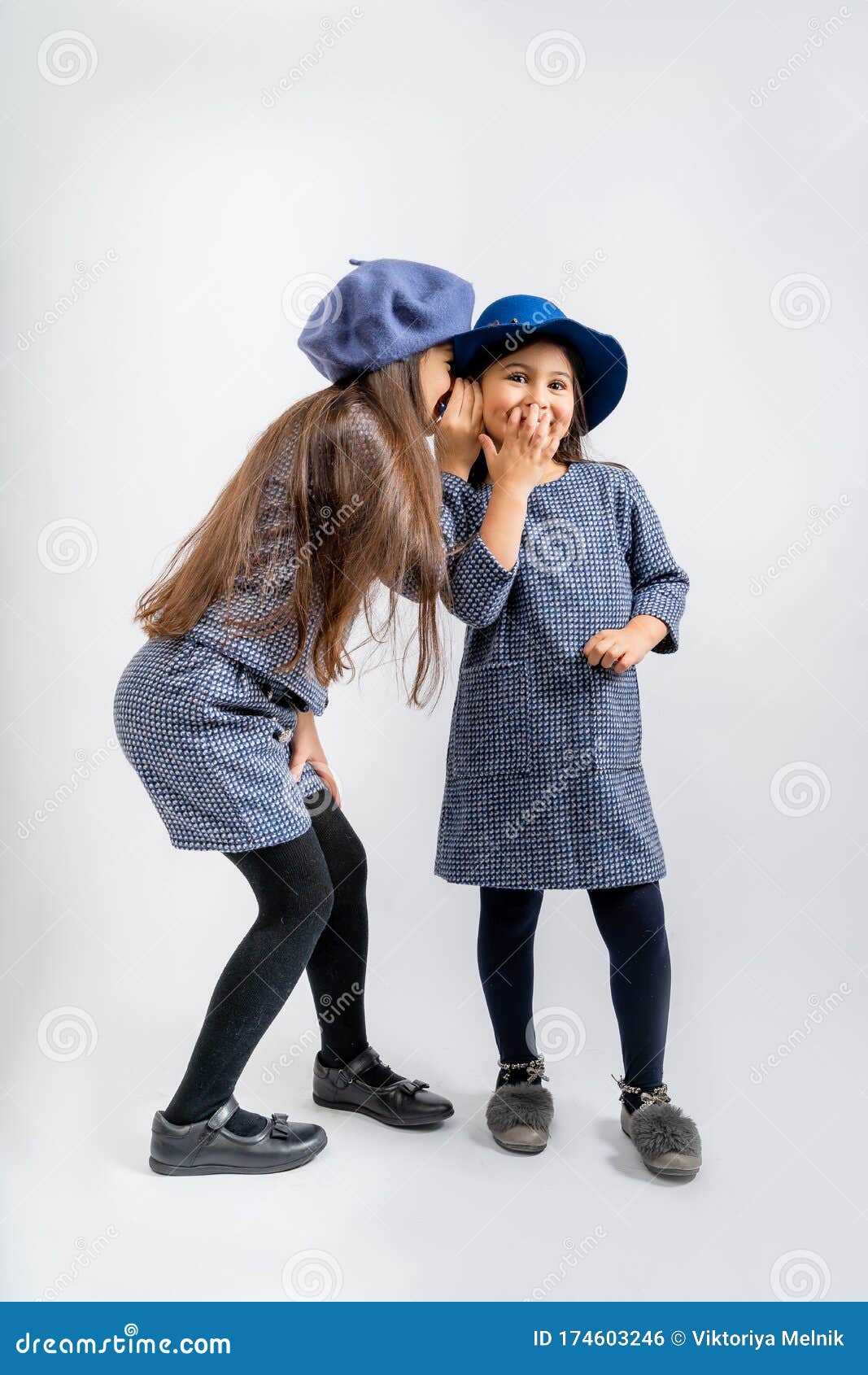 children in a blue jacket with white and black spots, a blue cap, blue shorts with the same spots, black tights, black shoes, a bl