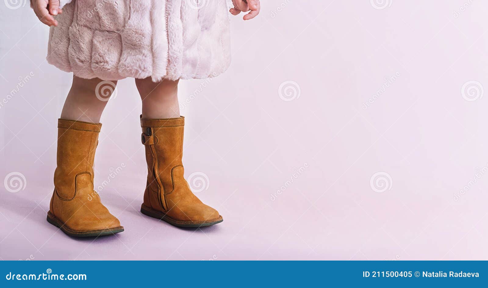 children boots shoes for little fashionistas on a pink background copyspace for text