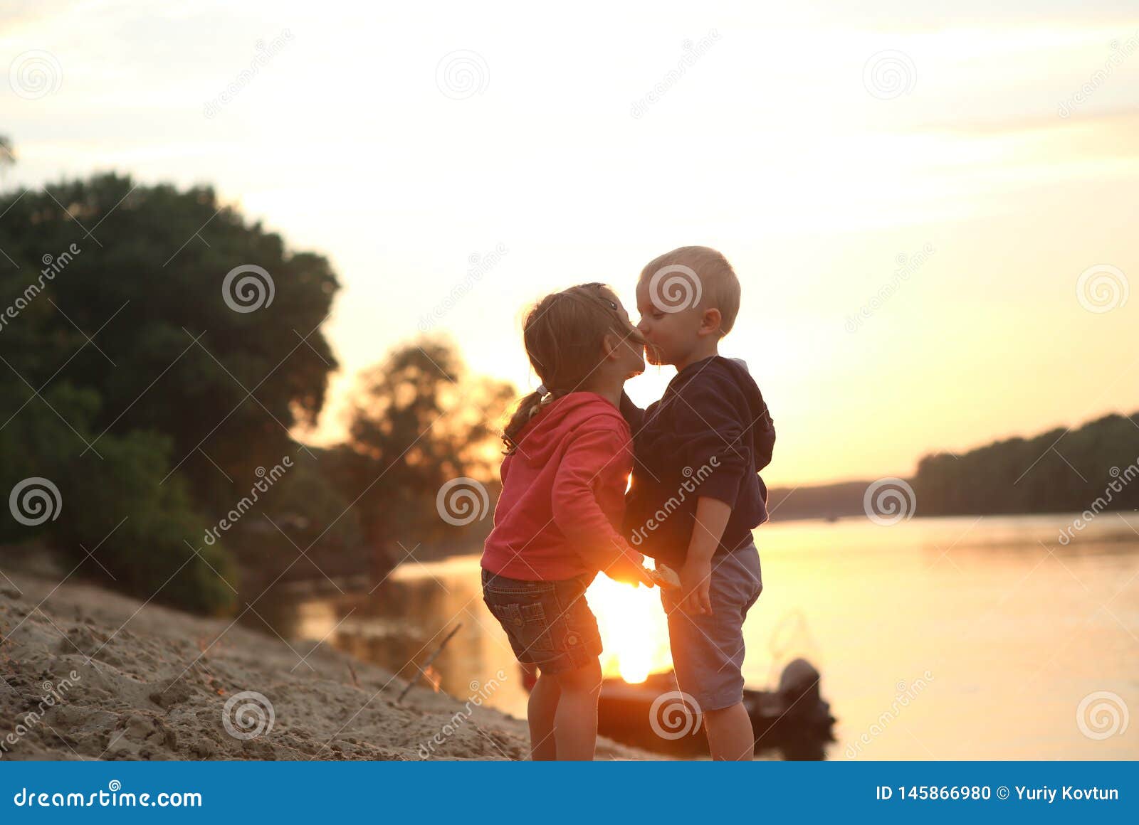 Children Boy And Girl Kiss Sunset River Stock Photo Image Of