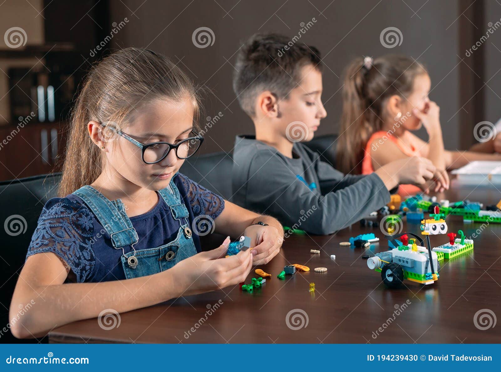 Children in the Classroom Collect Figure from the Designer. Stock Photo