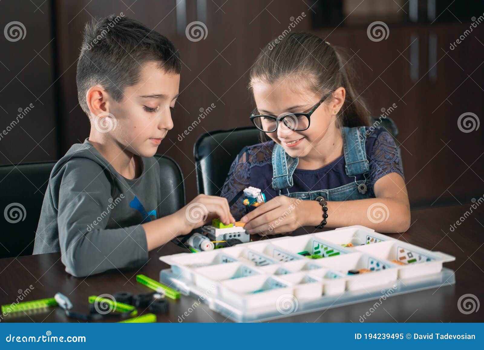 Children in the Classroom Collect Figure from the Designer. Stock Image