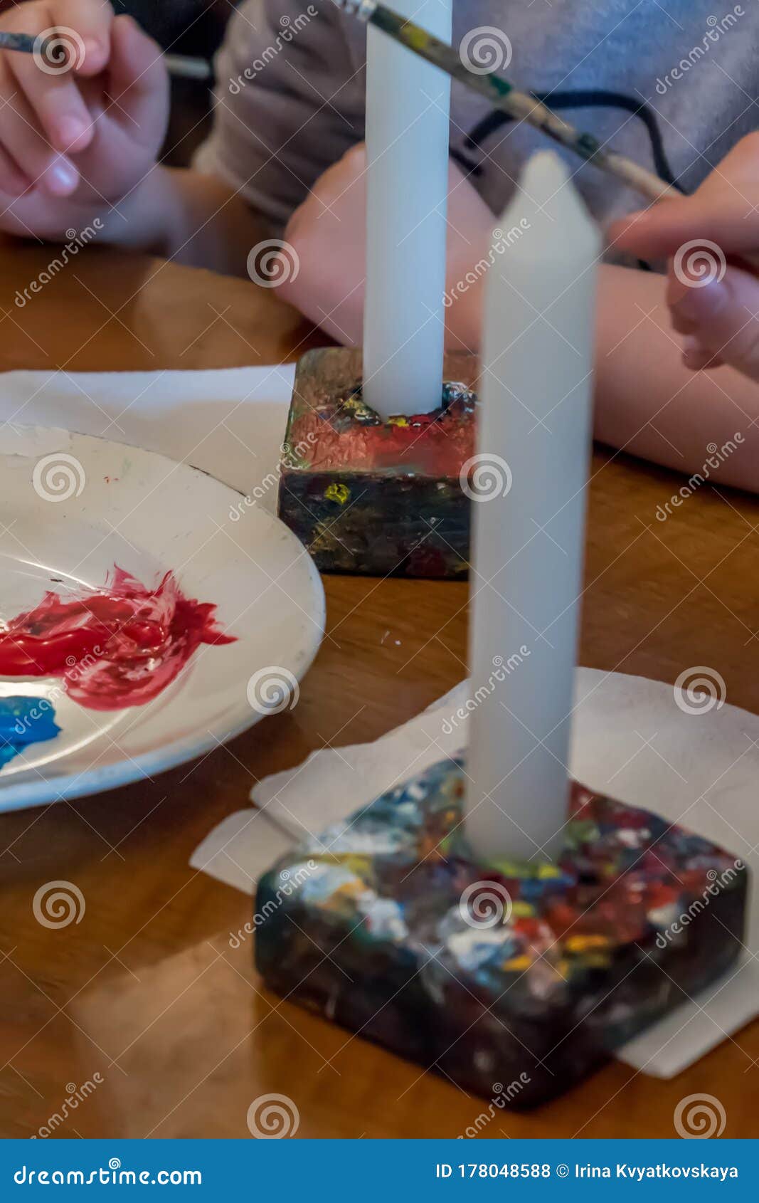 children colorize candles with acrylic paints