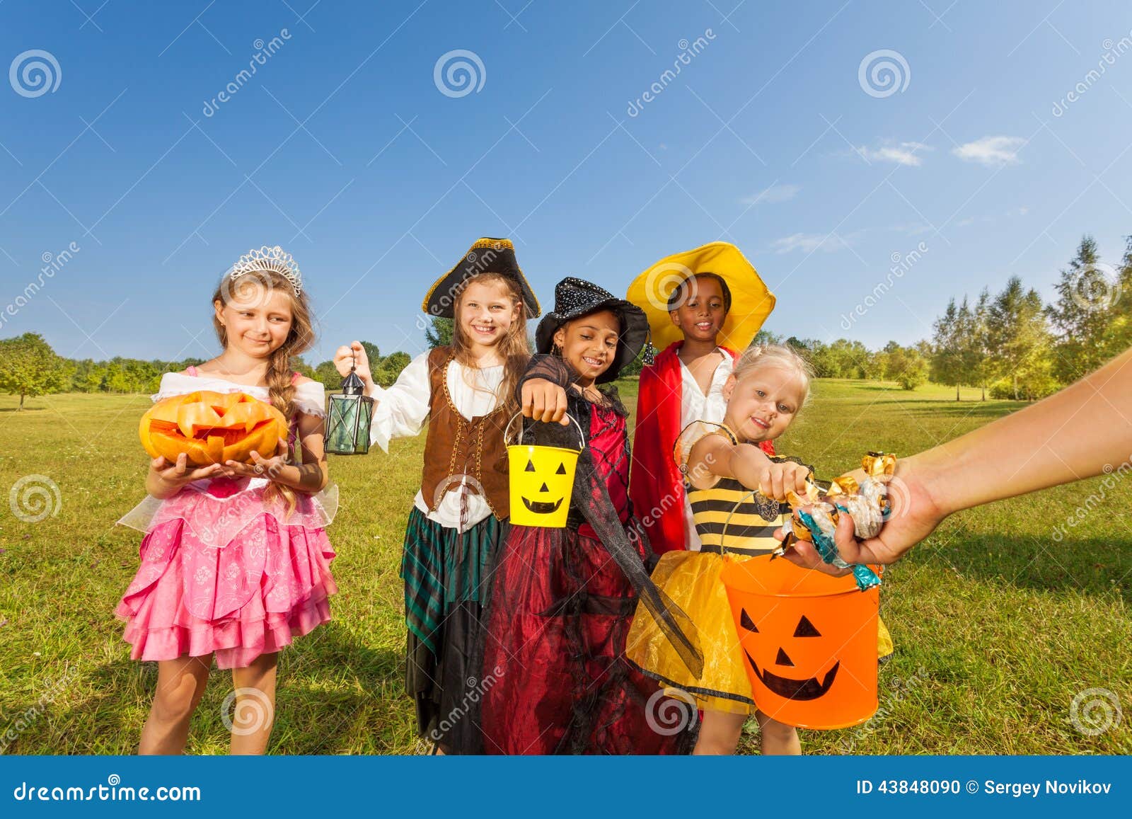 Children in Costumes Look at Hand with Sweets Stock Photo - Image of ...