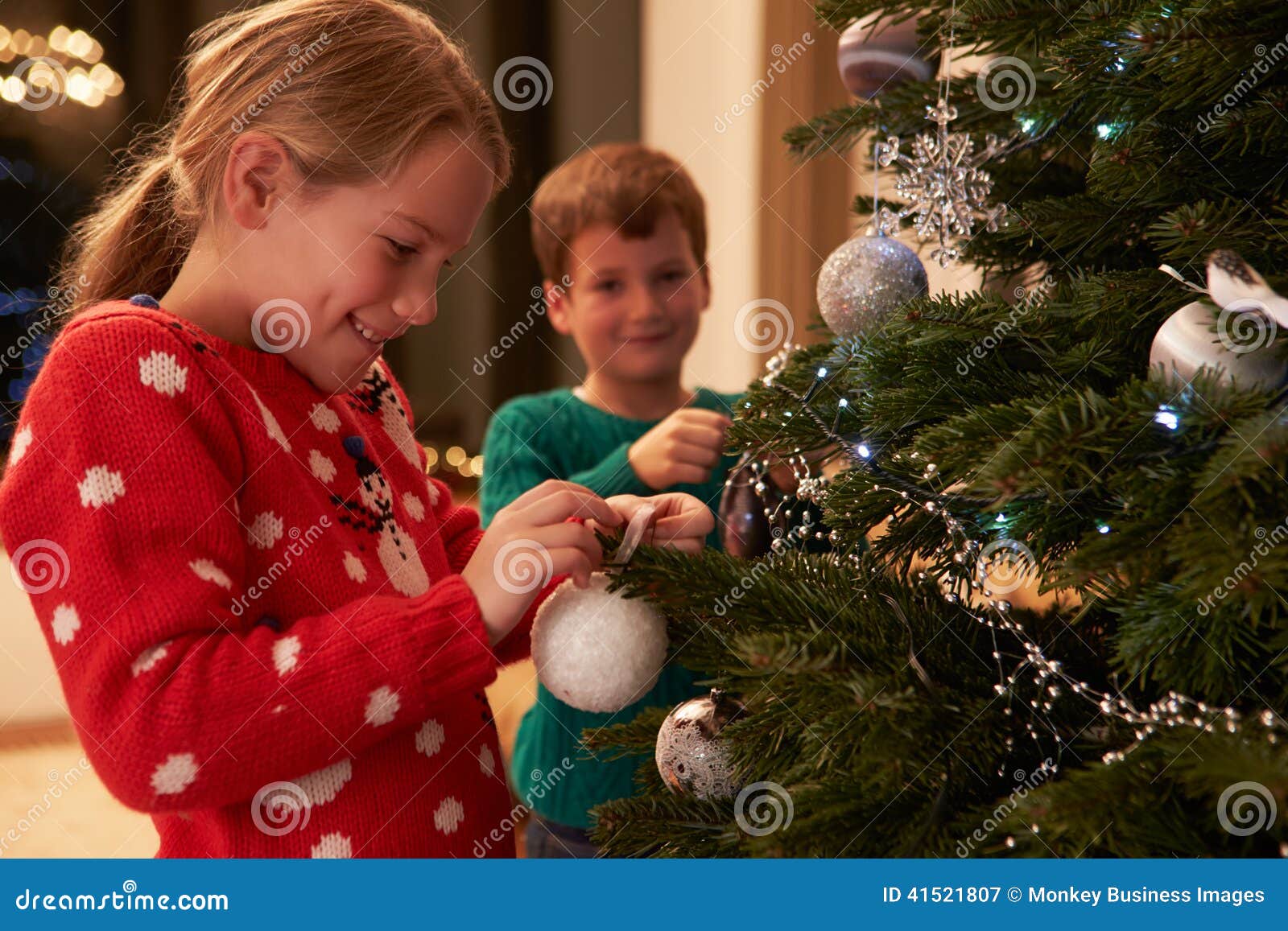 children decorating christmas tree at home