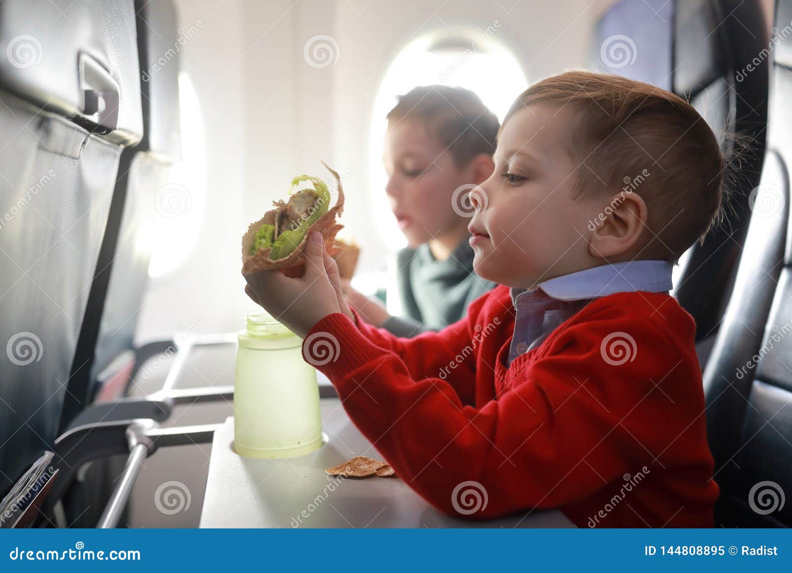 Children eat on the plane stock image. Image of aircraft 144808895