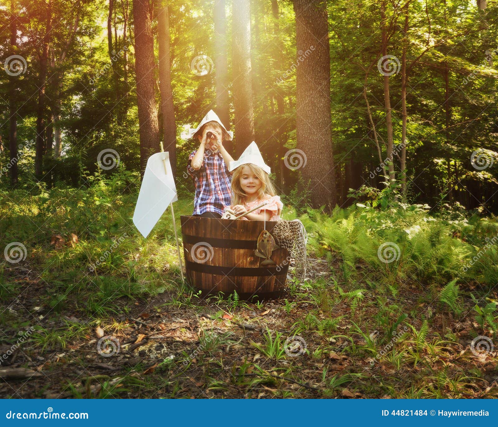 Children Fishing In Wooden Boat In Forest Stock Photo 