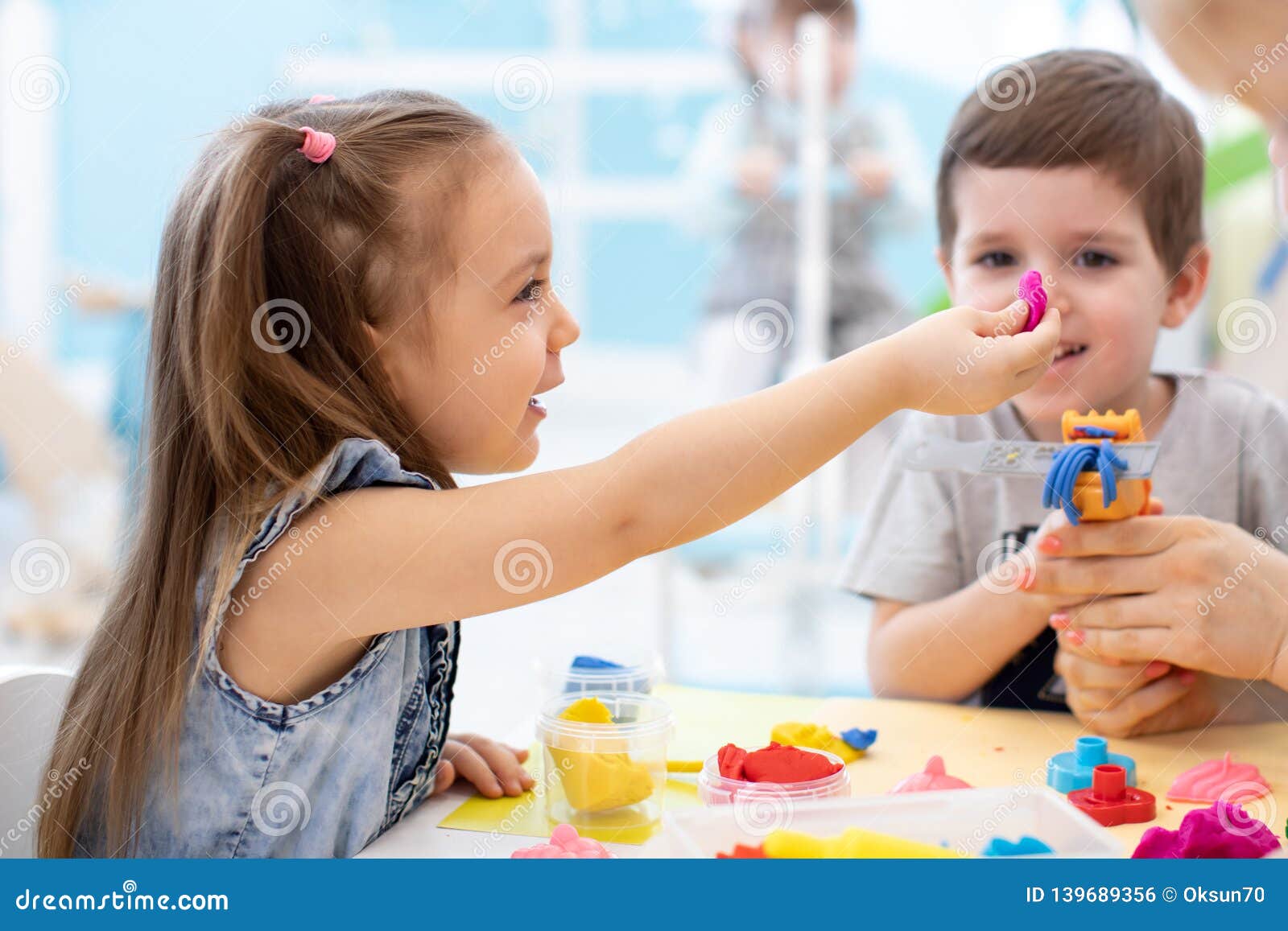 children girl and boy play in kids daycare center