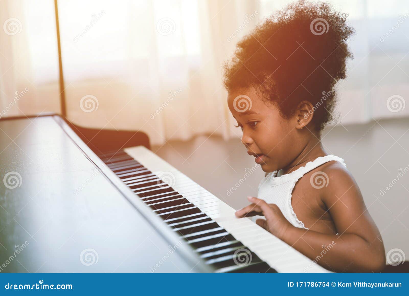 children girl playing piano looking exciting happy and enjoy with music instrument and be player