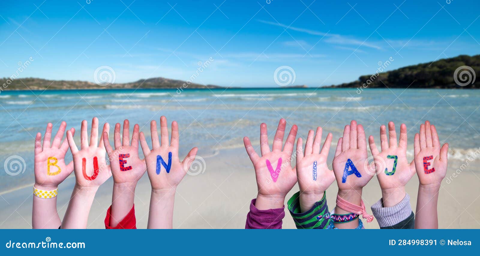 children hands building word buen viaje means good trip, ocean and sea