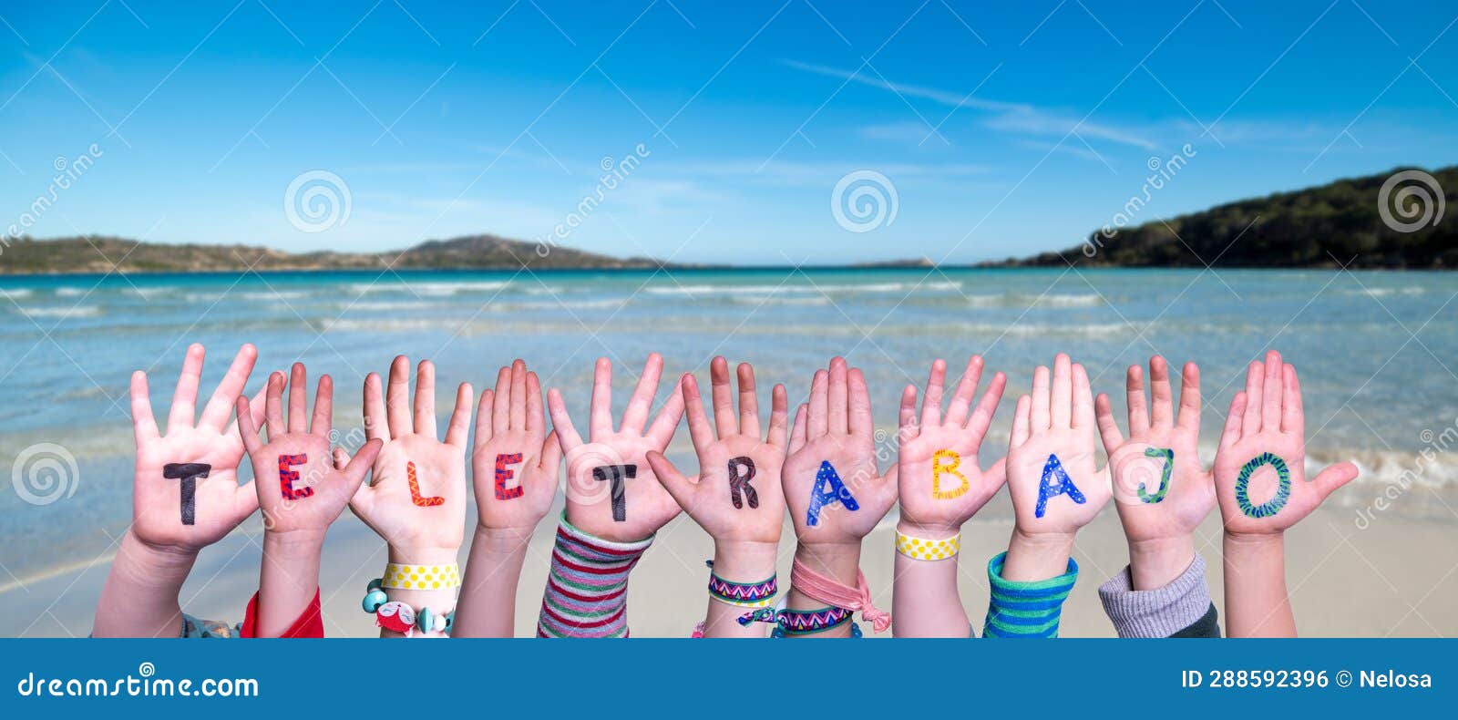 children hands building word teletrabajo means teleworking, ocean and sea