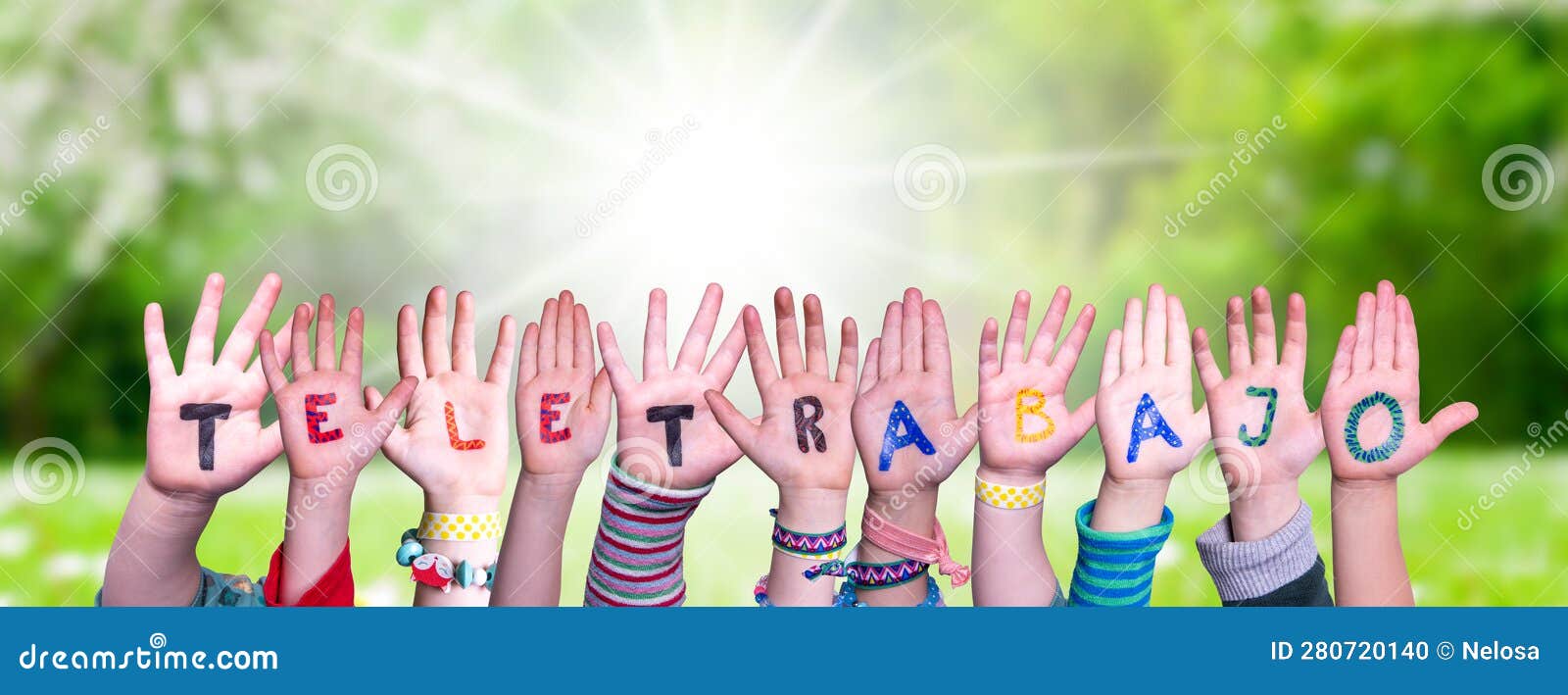 children hands building word teletrabajo means teleworking, grass meadow