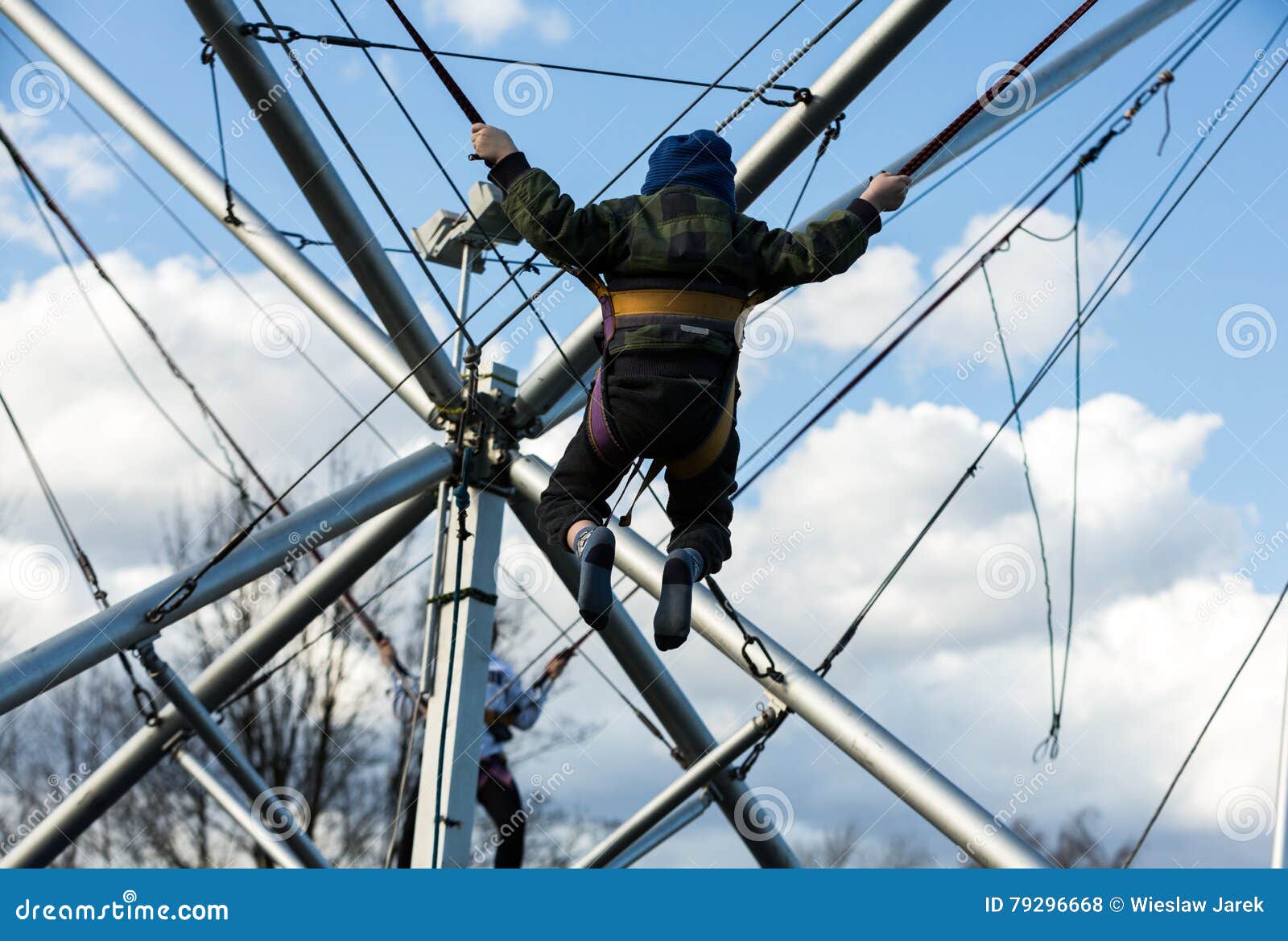 Children Have Fun Jumping on Bungee Trampoline Secured with Rubber