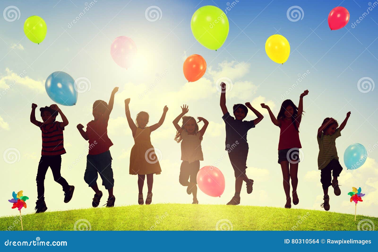 children outdoors playing balloons togetherness concept