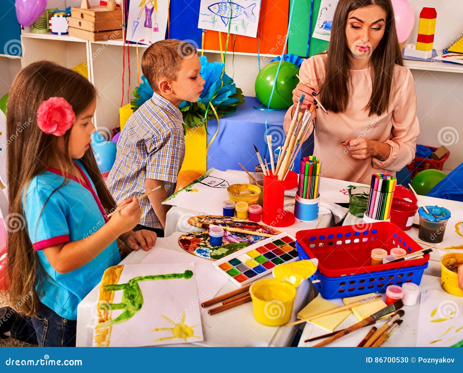 Children Painting and Drawing Together . Craft Lesson in Primary School