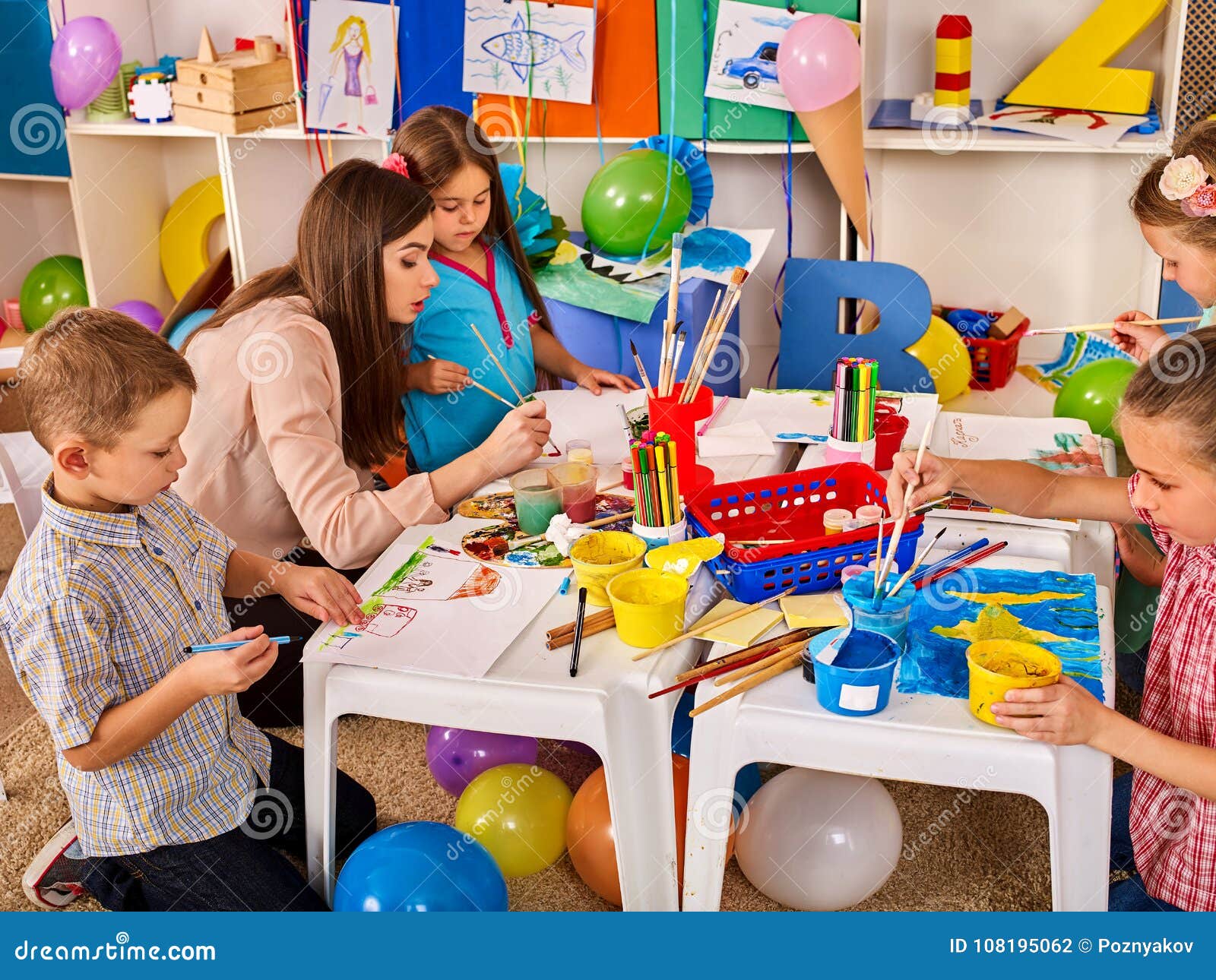 Children Painting and Drawing Together. Craft Lesson in Primary School