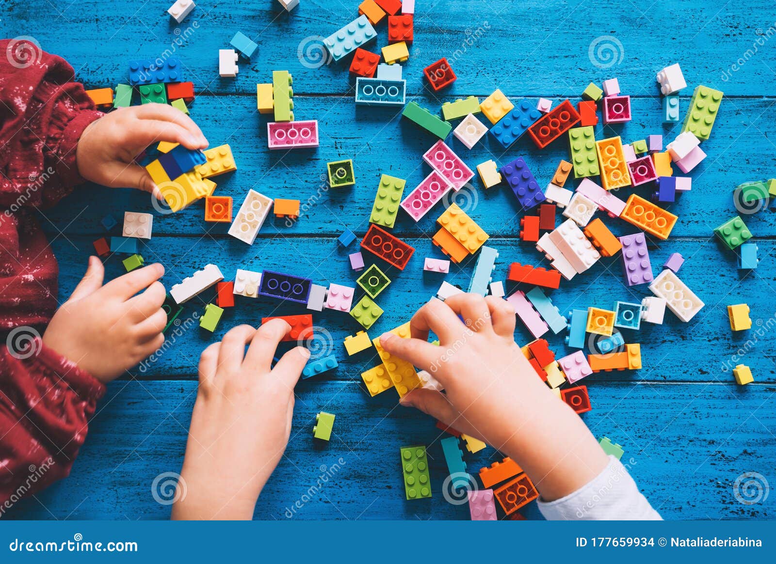 children play and build with colorful toy bricks, plastic blocks