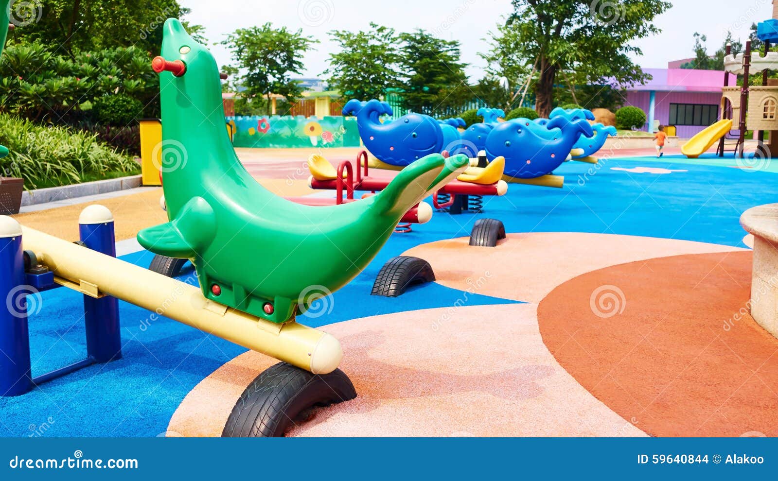 Seesaw on outdoor children playground in park. Colorful play equipment on kids playground.