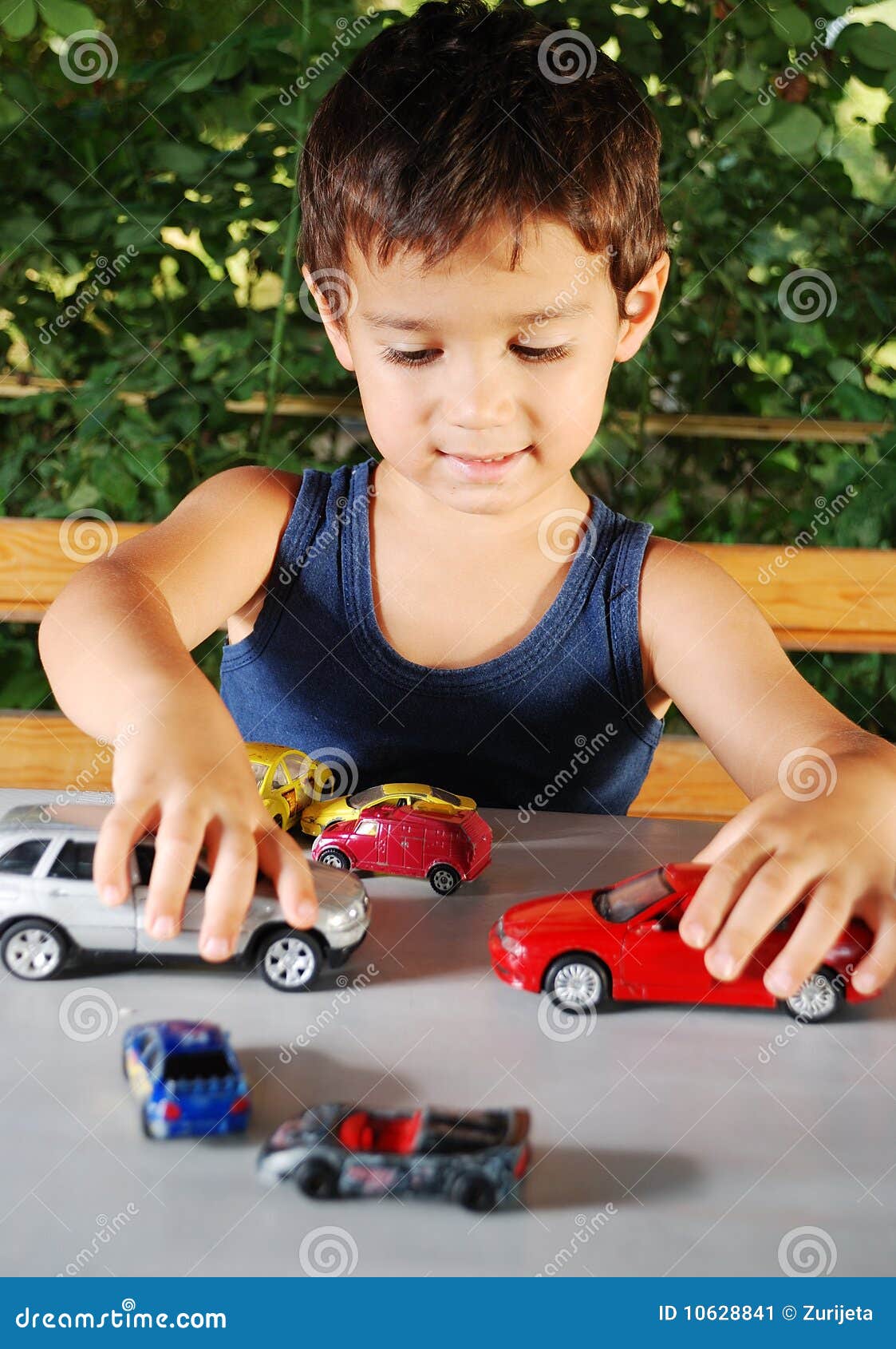 child playing with cars