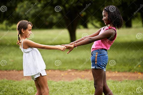 Children Playing Ring Around The Rosie In Park Stock Photo Image Of