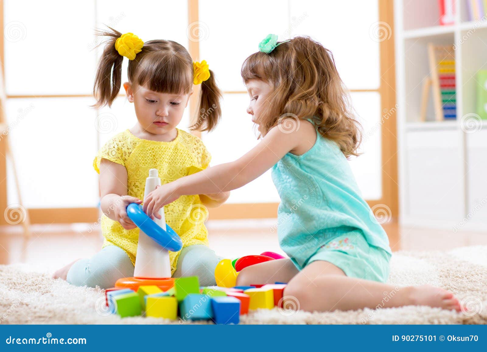 children playing together. toddler kid and baby play with blocks. educational toys for preschool and kindergarten child