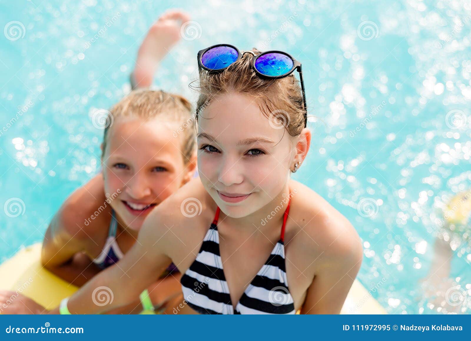 children rest in the pool in summer