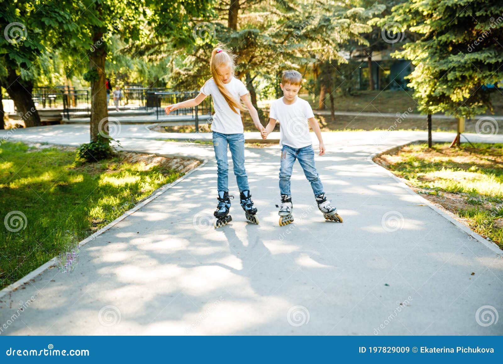 Children Ride on Roller Skates in the Park. Stock Image Image of